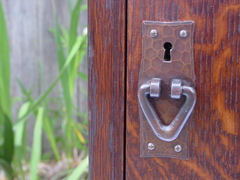 Detail hand hammered copper door pull.